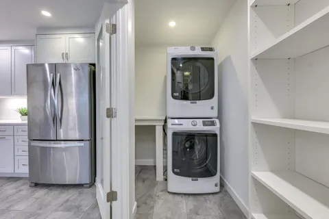 a kitchen with a refrigerator and a sink