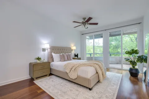 a bedroom with a large bed and a potted plant