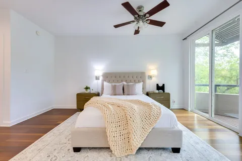 a bedroom with a bed and large window