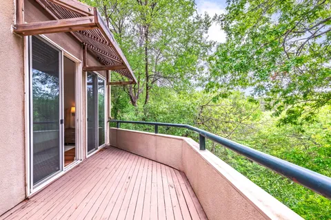 a view of balcony with wooden floor