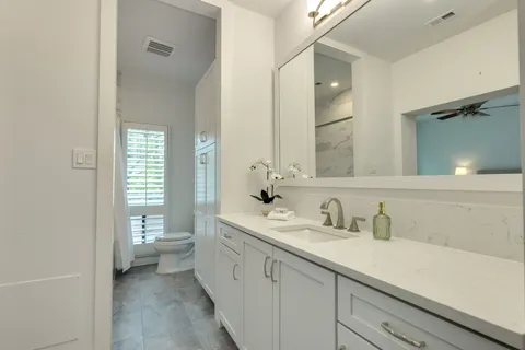 a bathroom with a sink a toilet and a mirror