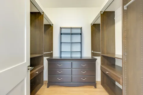 a bathroom with a tub and a double vanity sink