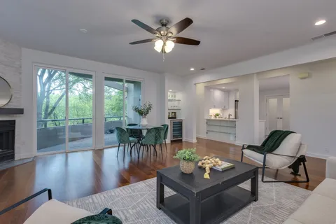 a living room with furniture and a large window with wooden floor