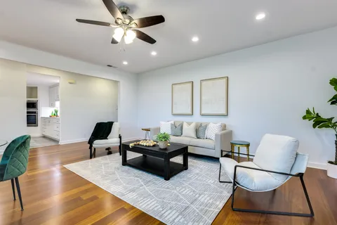 a living room with furniture and wooden floor