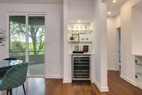 a view of dining room with wooden floor and windows
