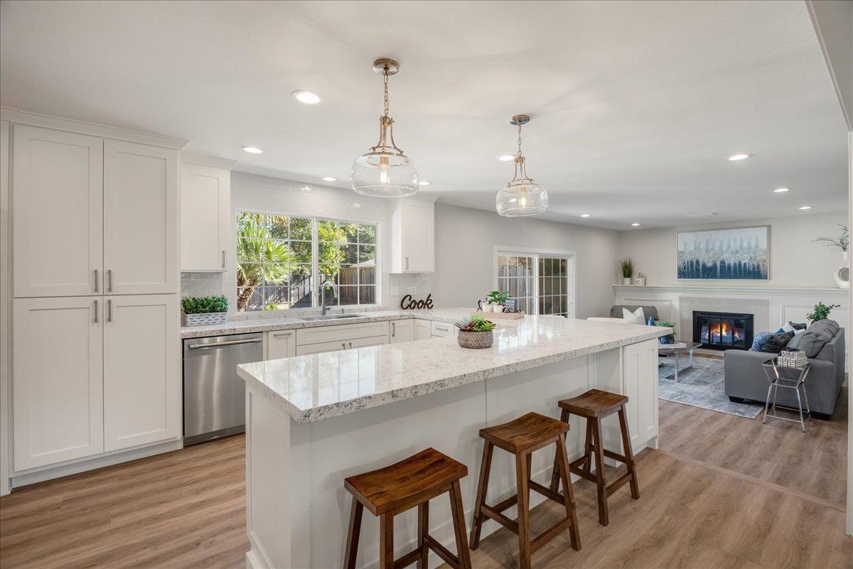 7106 Brooktree Way San Jose, CA 95120 - Photo 10 of 31 a kitchen with stainless steel appliances granite countertop wooden floor window and cabinets