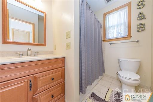 304 John Street Middlesex, NJ 08846 - Photo 11 of 25 a bathroom with a toilet a sink and a window