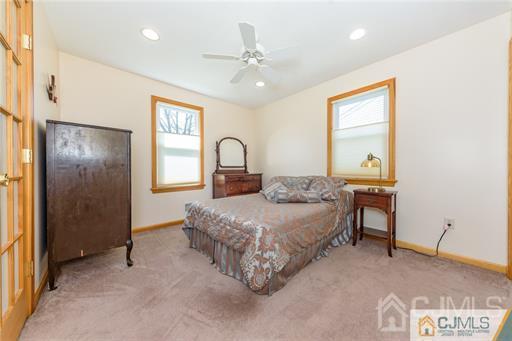 304 John Street Middlesex, NJ 08846 - Photo 15 of 25 a bedroom with a large bed and a chandelier