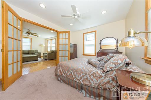 304 John Street Middlesex, NJ 08846 - Photo 16 of 25 a spacious bedroom with a bed mirror dresser and a large window