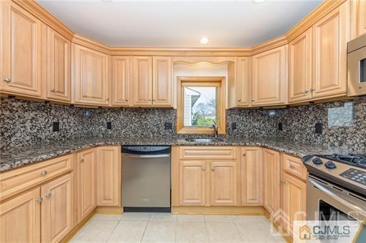 304 John Street Middlesex, NJ 08846 - Photo 20 of 25 a kitchen with stainless steel appliances granite countertop a sink stove and cabinets
