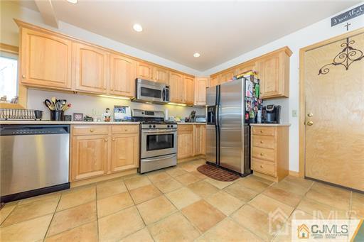 304 John Street Middlesex, NJ 08846 - Photo 5 of 25 a kitchen with stainless steel appliances granite countertop a stove a sink and a refrigerator