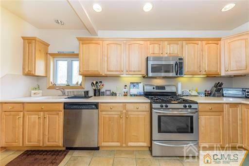 304 John Street Middlesex, NJ 08846 - Photo 6 of 25 a kitchen with a stove top oven sink and cabinets