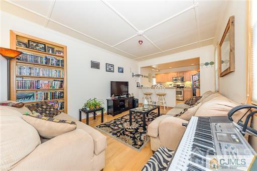 304 John Street Middlesex, NJ 08846 - Photo 8 of 25 a living room with furniture or couch and a bookshelf