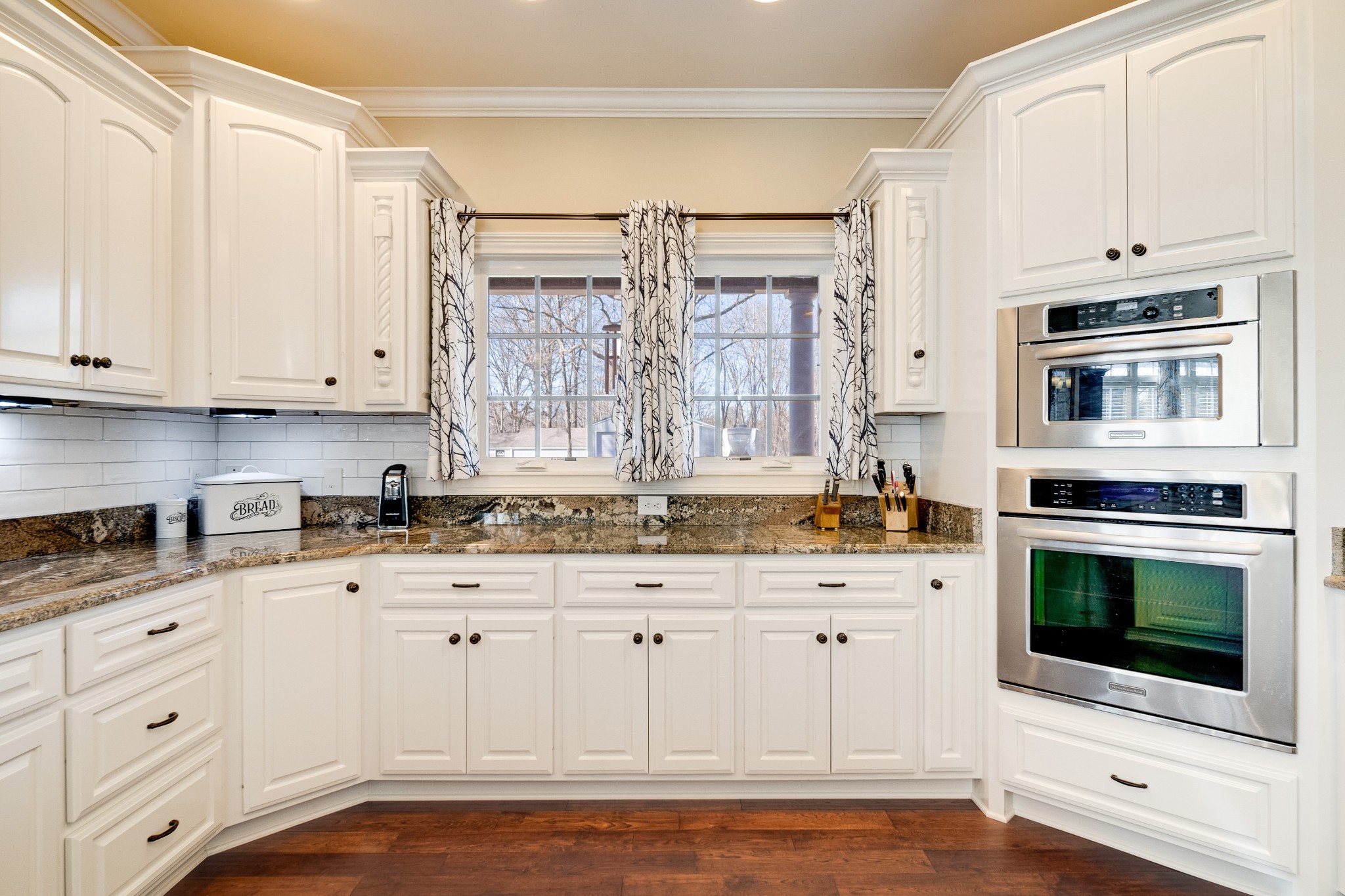 236 Raymond Hodges Road Cottontown, TN 37048 - Photo 22 of 37 a kitchen with stainless steel appliances granite countertop a stove a sink and white cabinets