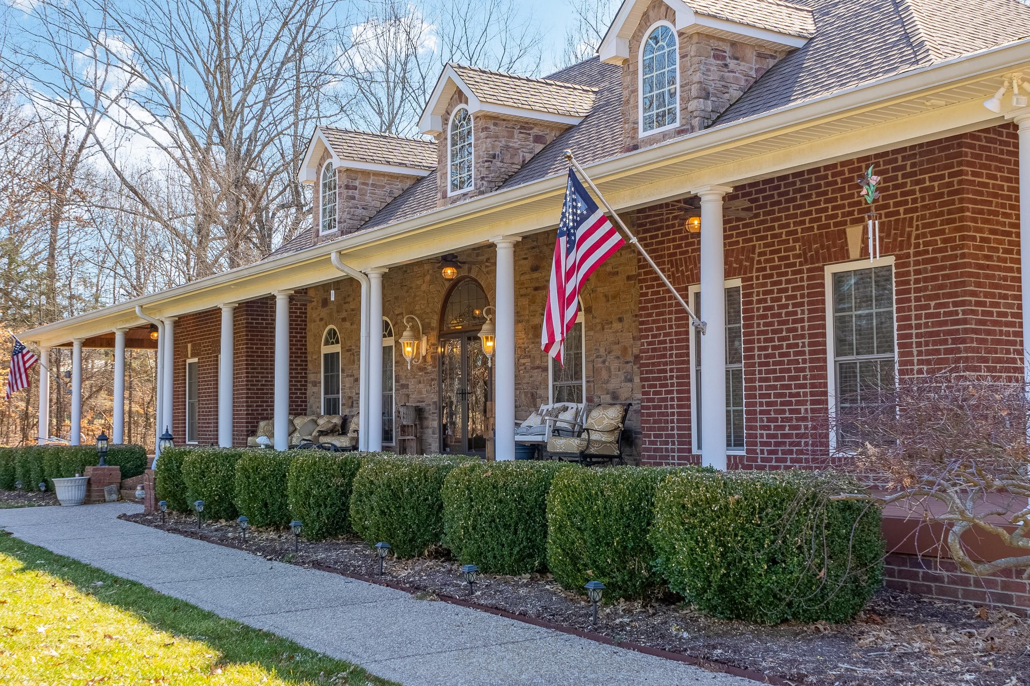 236 Raymond Hodges Road Cottontown, TN 37048 - Photo 6 of 37 a view of a house with large windows and a yard with plants and furniture