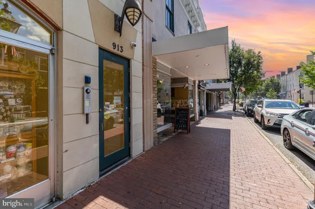 a view of a building with car parked