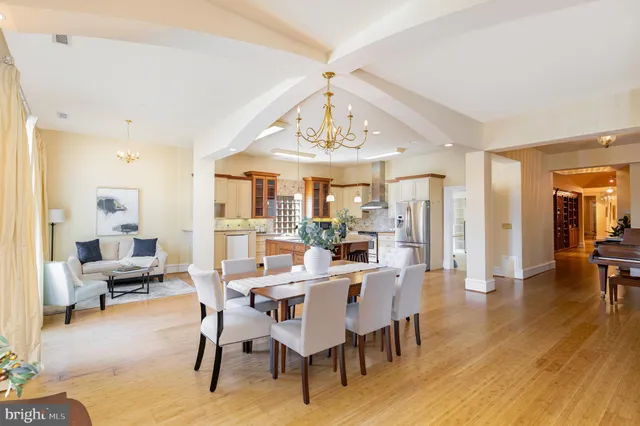 a view of a dining room with furniture wooden floor and chandelier