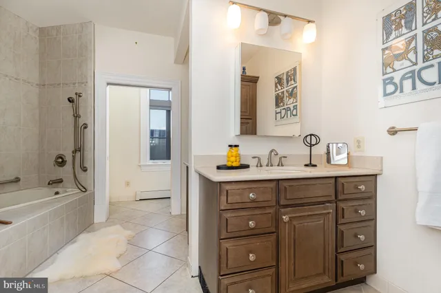 a bathroom with a sink vanity and a mirror