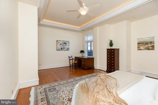 a bedroom with furniture and wooden floor
