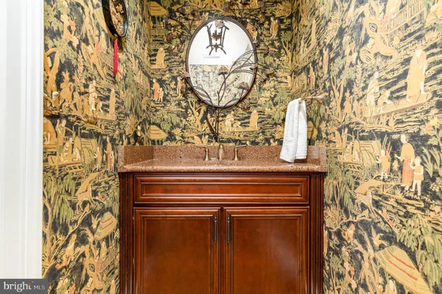 a bathroom with a granite countertop sink mirror and double