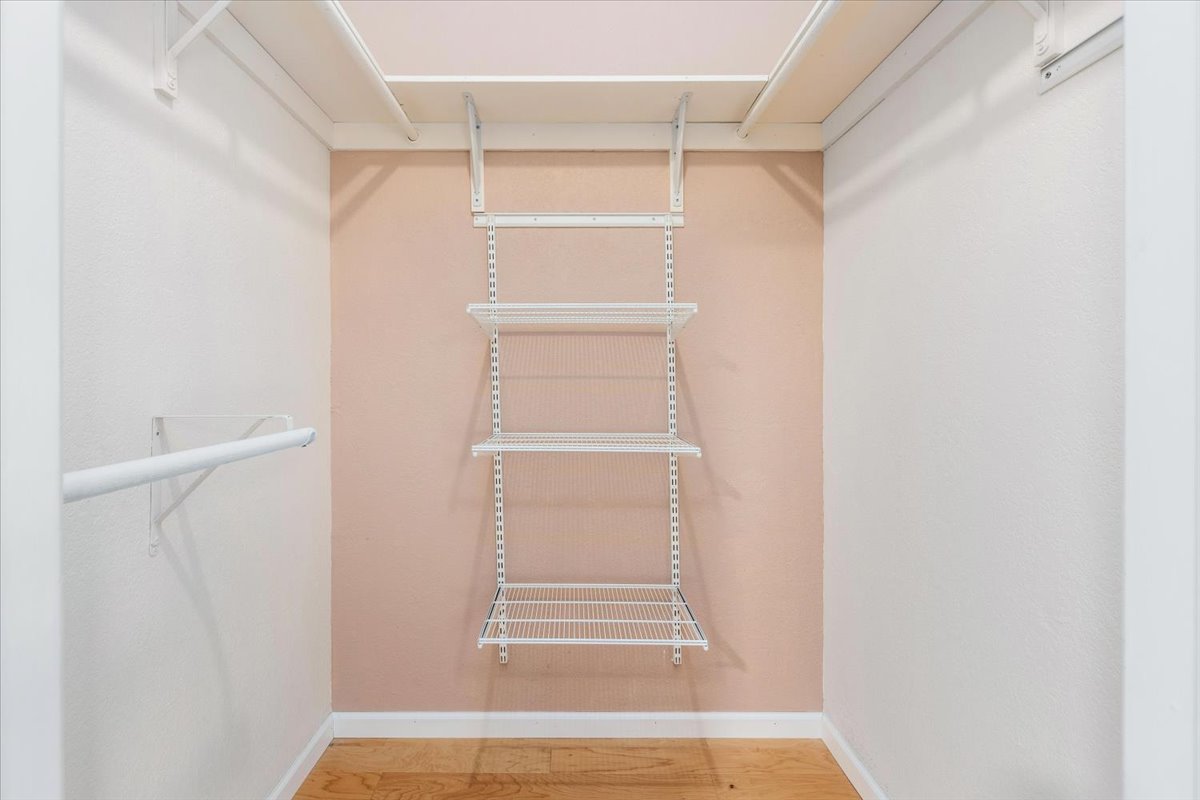 4711 Spicewood Springs Road, Unit 4222 Austin, TX 78759 - Photo 21 of 35 Streamlined walk-in closet offers organization with shelving and ample hanging space.
