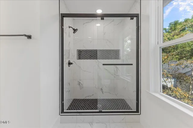 a bathroom with a glass shower door