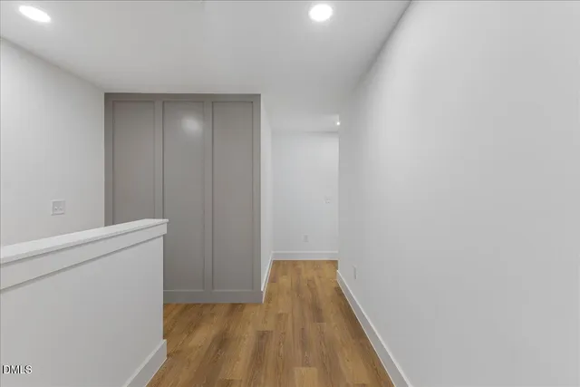 a view of hallway with wooden floor