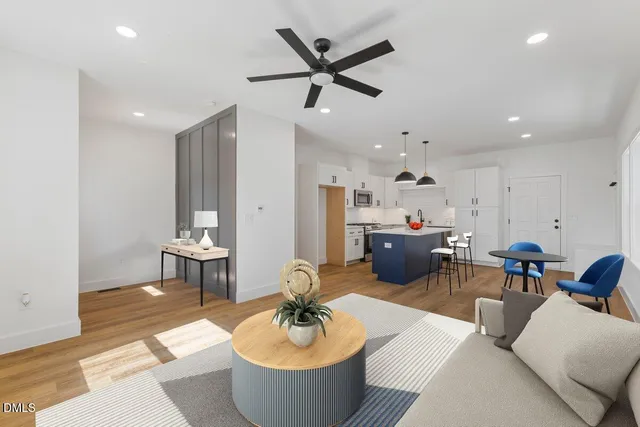 a living room with furniture and a wooden floor