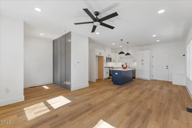 a kitchen with stainless steel appliances a refrigerator sink and white cabinets