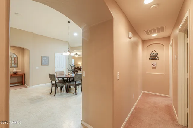 a view of a dining room with furniture and a chandelier