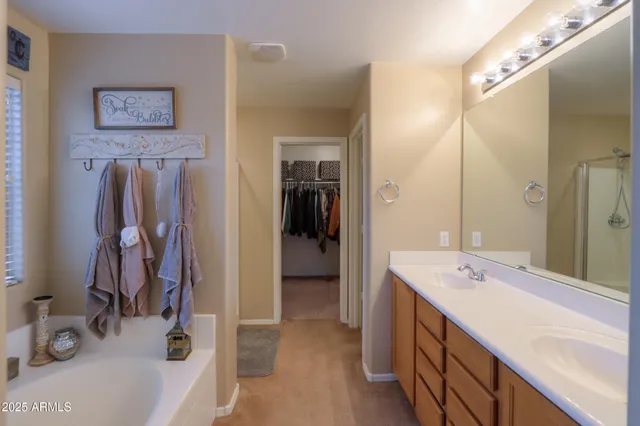 a bathroom with a tub sink and mirror