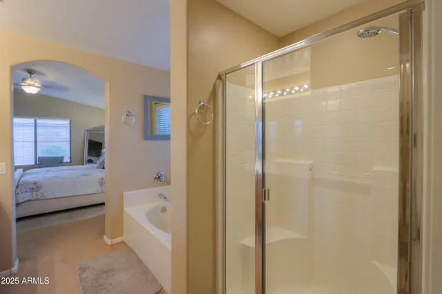 a bathroom with a bathtub shower and a sink