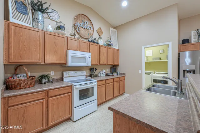 a kitchen with stainless steel appliances granite countertop a sink stove and cabinets
