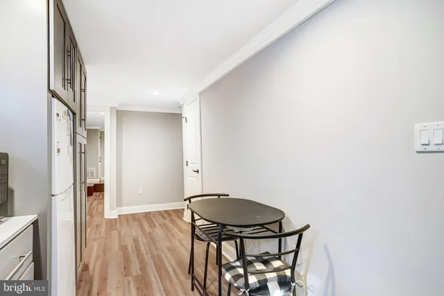 a kitchen with stainless steel appliances granite countertop a refrigerator a stove and a sink with wooden floor