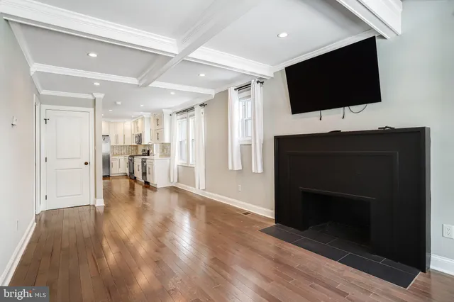 a living room with a fireplace and a flat screen tv