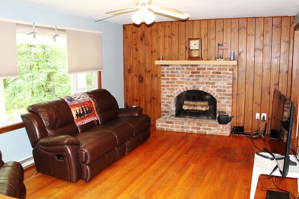 230 West Sutton Road Sutton, MA 01590 - Photo 8 of 28 a living room with furniture and a fireplace