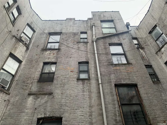 an aerial view of a brick building with many windows