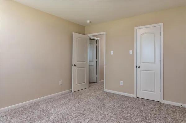 an empty room with closet area