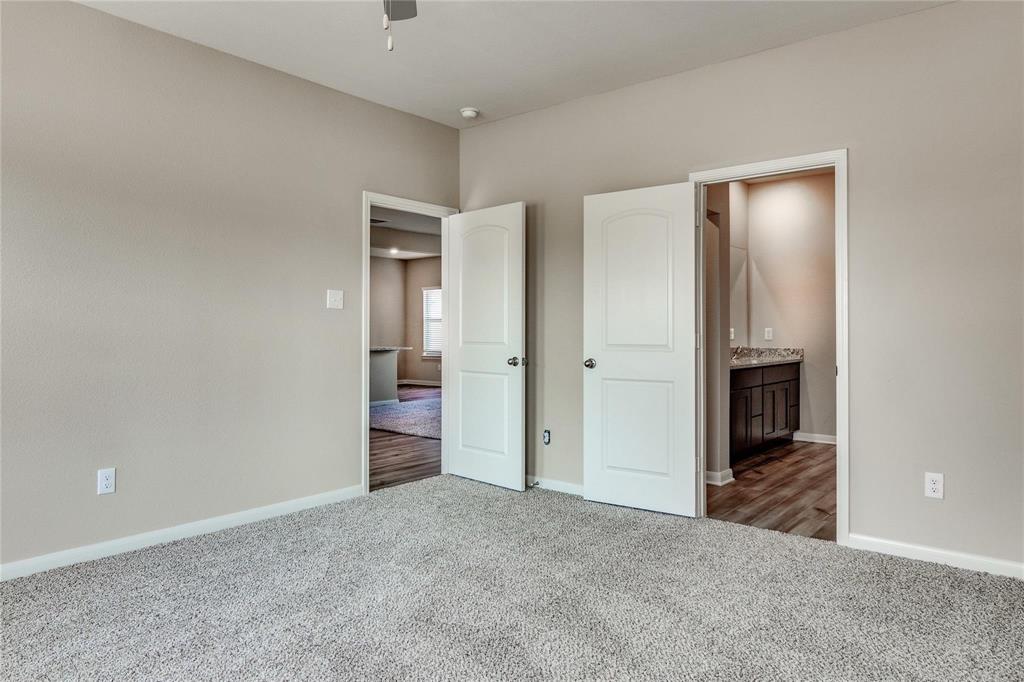 216 Lake Ridge Princeton, TX 75407 - Photo 16 of 20 a view of a hallway with wooden cabinet and a fireplace