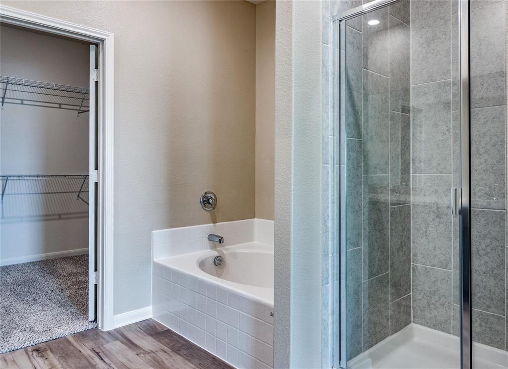 216 Lake Ridge Princeton, TX 75407 - Photo 18 of 20 a bathroom with a bathtub and a shower
