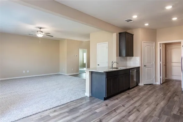 a large kitchen with a refrigerator and a sink