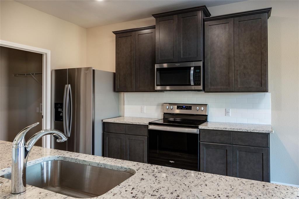 216 Lake Ridge Princeton, TX 75407 - Photo 5 of 20 a kitchen with a refrigerator sink and microwave
