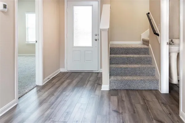 a view of entryway with wooden floor
