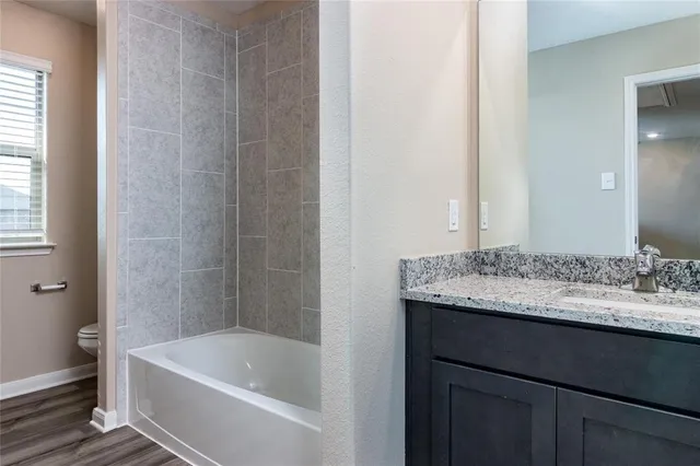 a bathroom with a bath tub and a sink