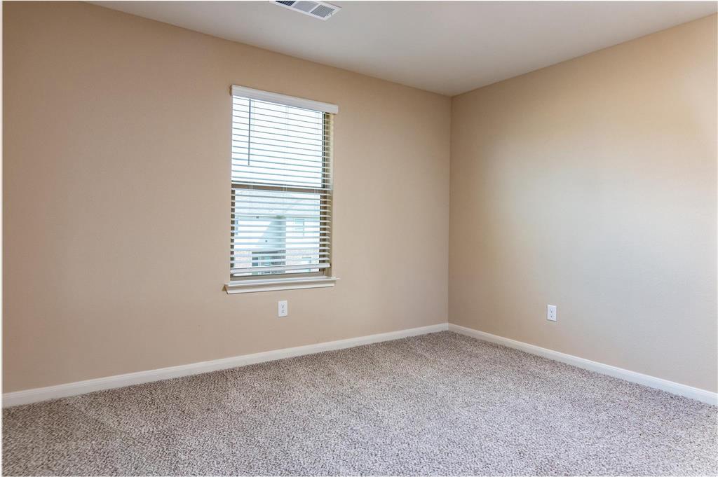 216 Lake Ridge Princeton, TX 75407 - Photo 10 of 20 an empty room with a window