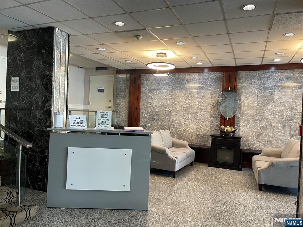 90 Prospect Avenue, Unit 8E Hackensack, NJ 07601 - Photo 16 of 21 a living room with furniture and a fireplace