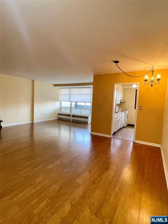 90 Prospect Avenue, Unit 8E Hackensack, NJ 07601 - Photo 2 of 21 a view of a room with wooden floor