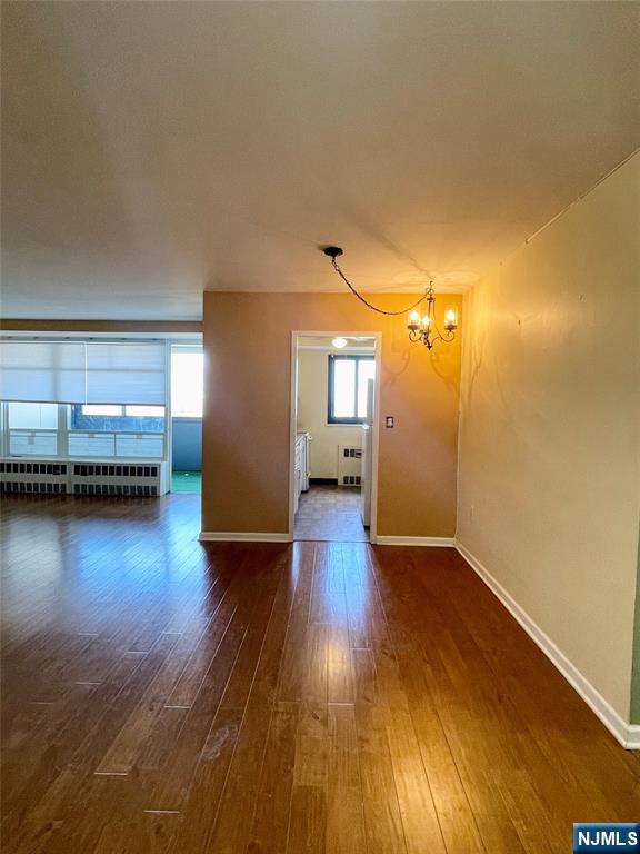 90 Prospect Avenue, Unit 8E Hackensack, NJ 07601 - Photo 3 of 21 a view of a room with wooden floor and a window
