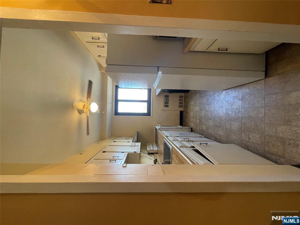 90 Prospect Avenue, Unit 8E Hackensack, NJ 07601 - Photo 4 of 21 a kitchen with a refrigerator a sink and dishwasher