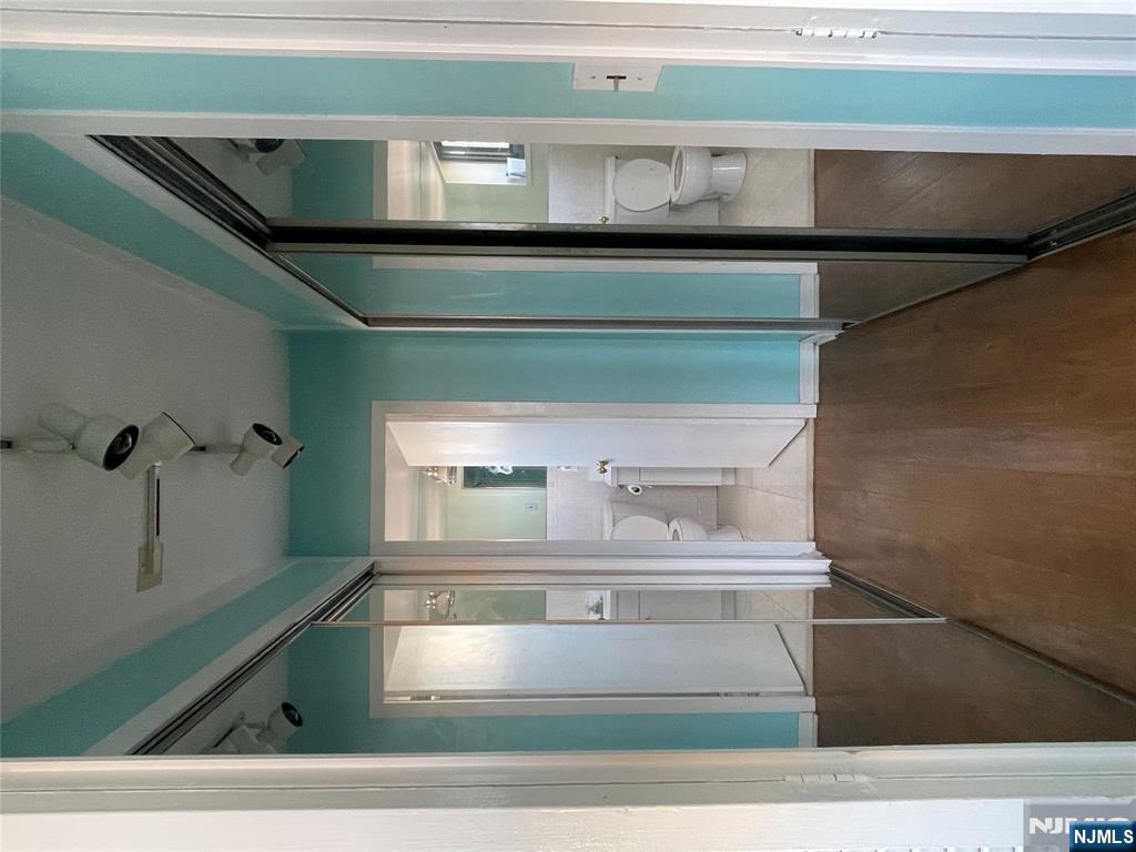 90 Prospect Avenue, Unit 8E Hackensack, NJ 07601 - Photo 7 of 21 a view of a bathroom from a hallway